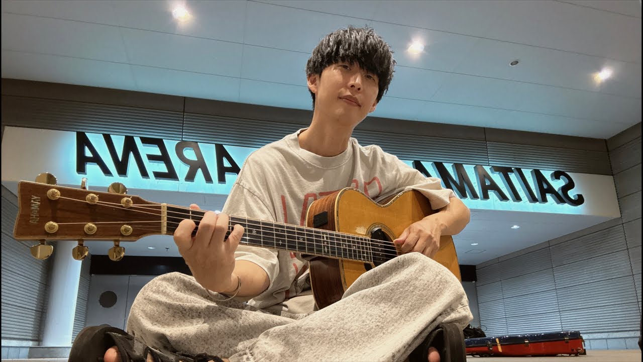 さいたまスーパーアリーナの前で弾き語りする男