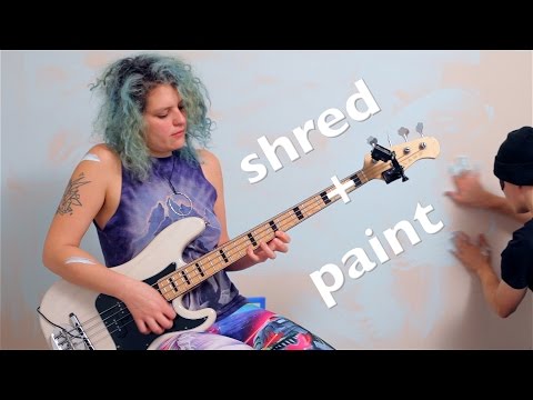 shredding bass Adrian Belew Power Trio's e  while a boy paints.