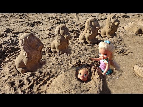 Elsa and Anna toddlers play in the sand