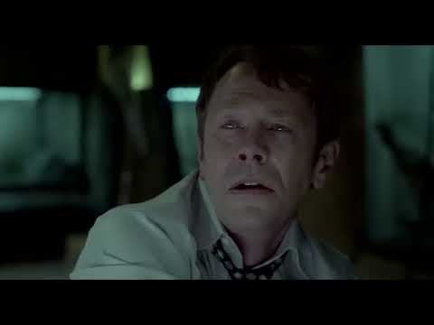Saw VI official trailer frame — Hoffman watches, traps prime, and the soundtrack’s metal-and-machines palette flickers