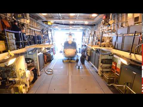HMS Somerset's Merlin helicopter is manouevred onto the ship's deck. Shetland Times video