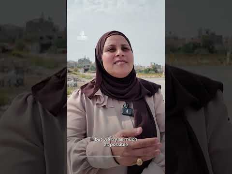 Palestinian children crawl under Israeli military gates to get to school