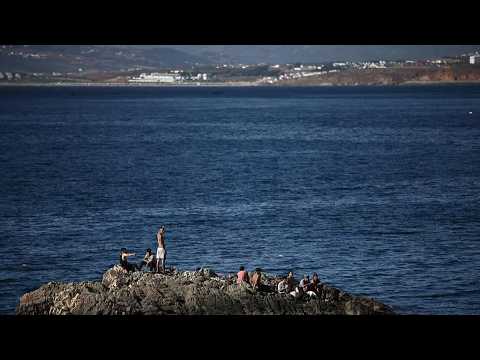 Live: Scenes of migrants and security forces on the beach in Spain's Ceuta