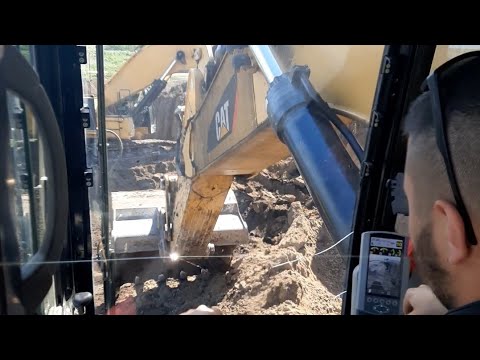 CAT 390F LME (CAB VIEW) loading muddy topsoil on trucks by frontal excavation