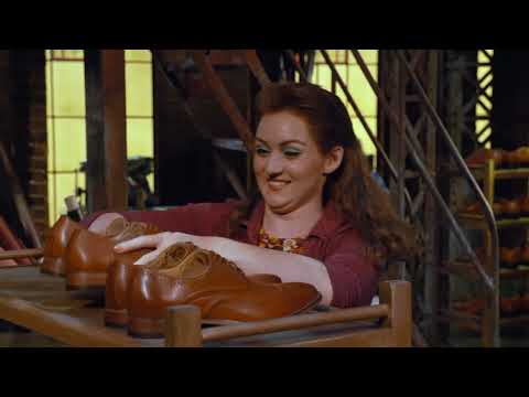 Final trailer beat with Milan runway silhouettes and a burst of red boots