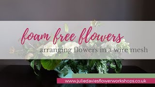Arranging flowers in a window sill vase using wire mesh