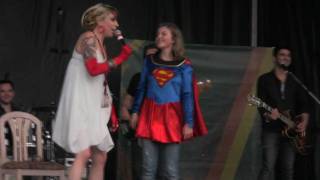 SuperGirl dances on stage with Suzie McNeil