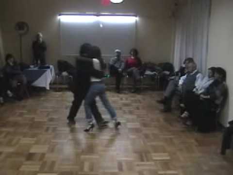  Pamela Ramos Aracena  and  Carlos Espinoza  are  dancing  to  a  tango