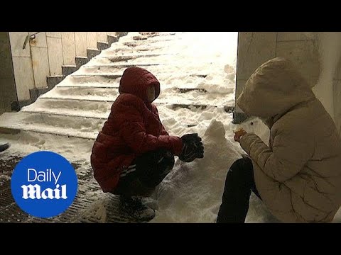 Russian people and tourists enjoy snowfall in capital Moscow - Daily Mail