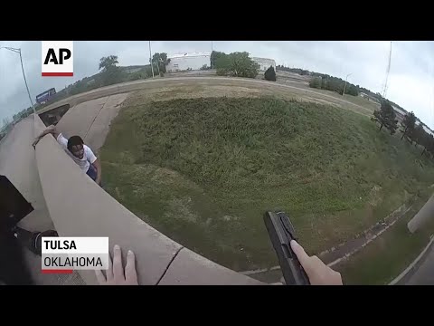 Video from a police body camera shows a shooting suspect falling about 30 feet from a bridge in Tulsa, Oklahoma, as officers chased him. (June 14)