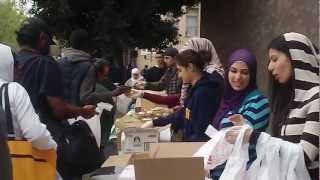 People handing out food on skid row - Downstreet$