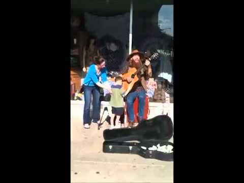Blind 8-year-old autistic boy stops to listen to street guitar guy.