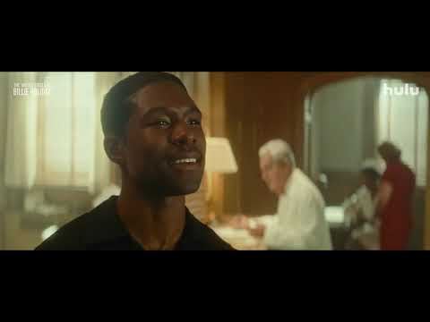 Trailer frame: Holiday at the microphone; the club lights dim as the audience hushes for Strange Fruit