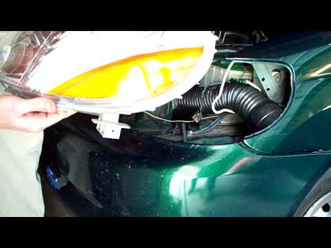 Slipping a new headlight housing onto an '00-'02 Echo