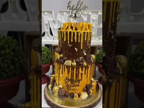 50th birthday cake in gold with all chocolate toppers #homebaker #cakes #baking #customizedcakes