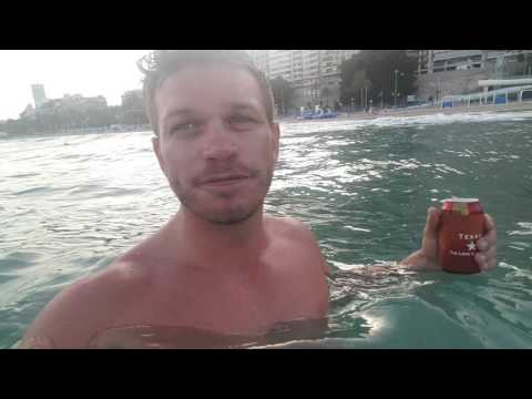 Alicante beach front, in the sea with a beer.