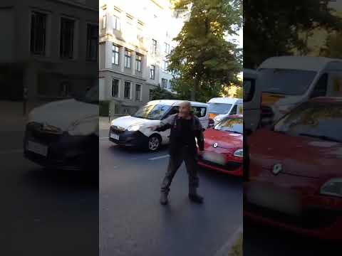 Motorist warns eco protesters then drives his car through their banner