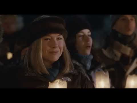 Trailer still: snowplow clearing a street as townspeople wave