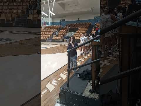 Me singing the National Anthem at a Basketball game.