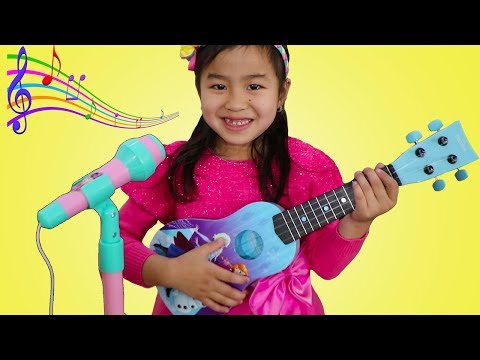 Jannie Plays with Disney Frozen Toy Guitar and Starts a Band