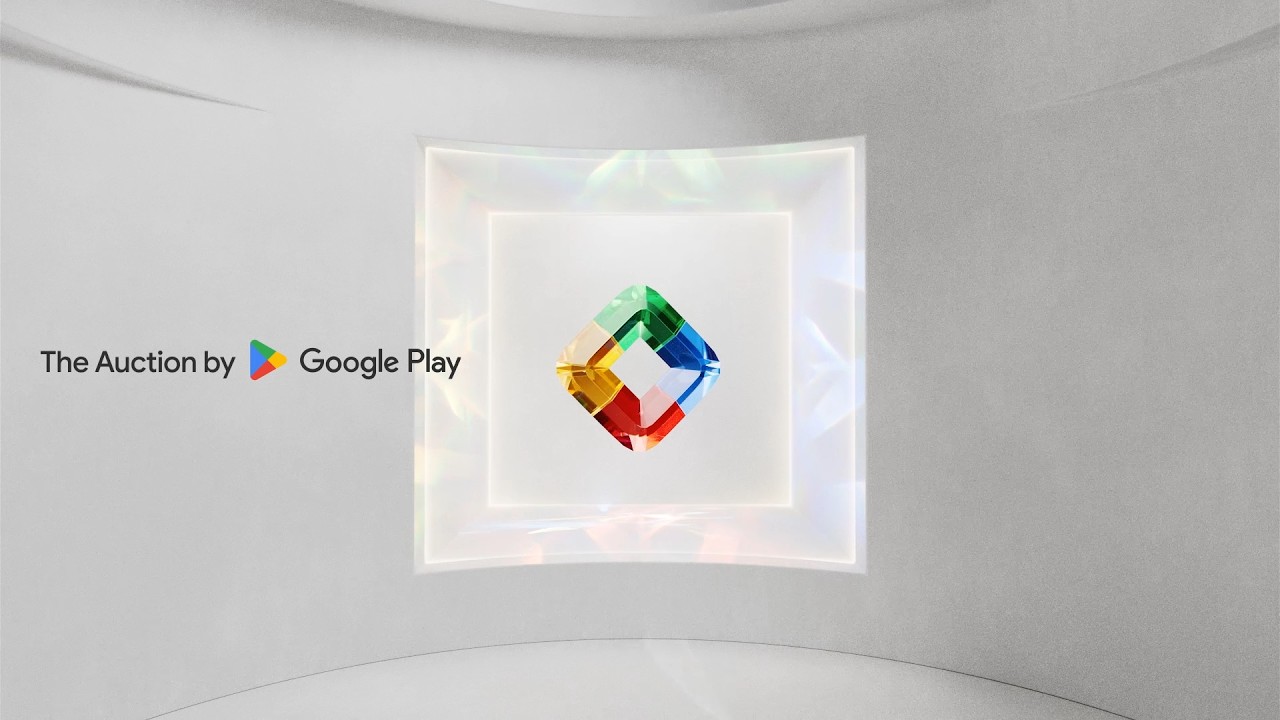 A video showcasing The Auction by Google Play experience at San Diego Comic-Con featuring several auction items within translucent spinning gems, including a game controller, turntable and vinyl records, and a gaming chair