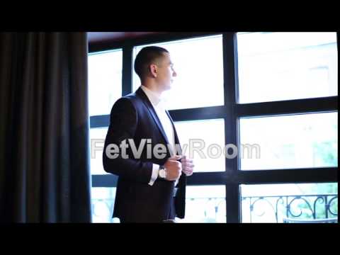 Young businessman in a classic suit standing in front of the window