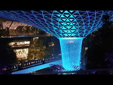 Changi Jewel Rain Vortex with Sky Train passing by