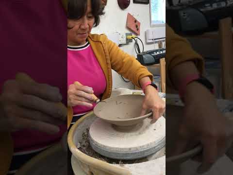 Trim inside pottery bowl to make even thickness