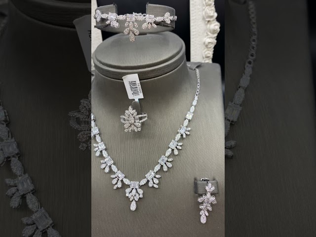 1- A set of 18 karat white gold