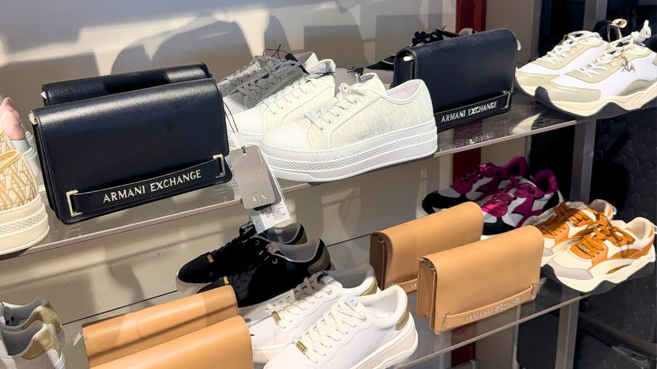 Armani Exchange sneakers and handbags in a retail store.
