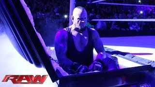 Undertaker rises from a coffin to attack Brock Les