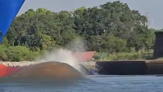 Dolphin jumping the wake of a container ship!