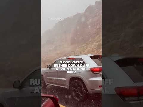 Flood water rushes down cliff at Zion National Park