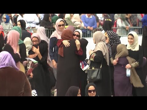 Prime Minister Jacinda Ardern, imam Gamal Fouda and thousands of others congregated in Hagley Park opposite the Al Noor mosque in Christchurch to observe the call to prayer and remember victims of the mosque attacks. (March 22)