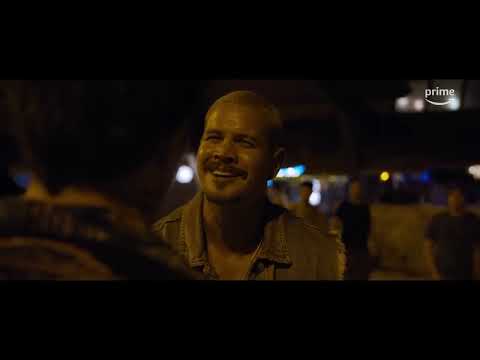 Trailer image: Dalton pushing through the crowd, stage lights flaring behind him