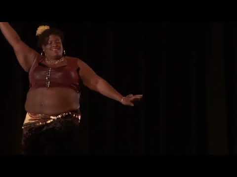 R. R. Peace performing a belly dance to "Haram Aleyk" in 2012.