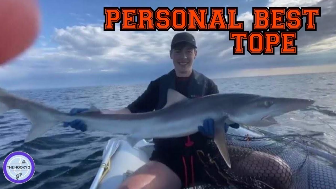 Happy fisherman holding monster tope