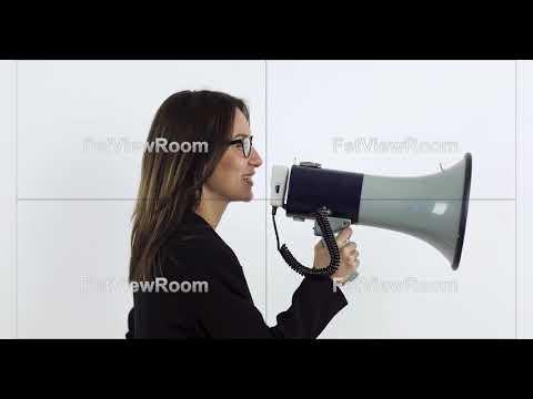 Beautiful business woman in glasses shouting through megaphone.