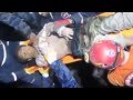 Turkish rescuers pull a man from the quake rubble.