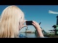 Rear View A Young Woman Is Photographing Old Windmills In The Netherlands Stock Footage