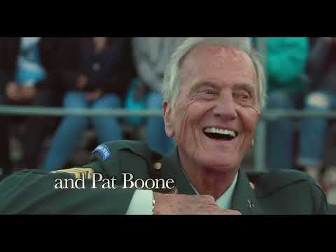 Trailer frame: quiet moment between characters that suits acoustic Americana cues