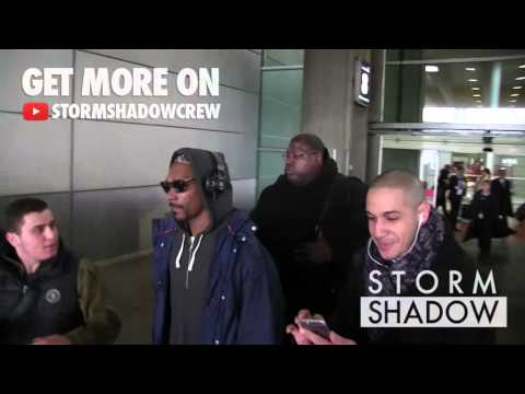 EXCLUSIVE: Newly grandad, Snoop Dogg arrives dancing at Paris airport