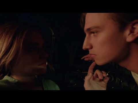 Romantic couple inside a car at night