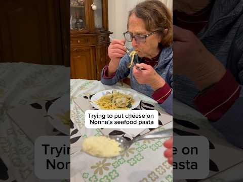 Trying to put cheese on Nonna’s seafood pasta