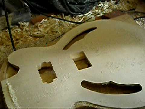 Soundholes and pickup holes cut on the Danny model guitar