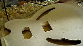 Soundholes and pickup holes cut on the Danny model guitar