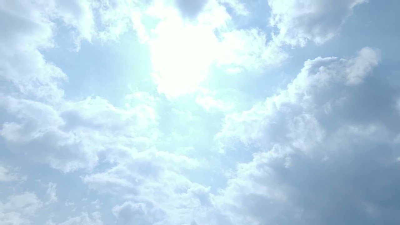 Bright Sunlight Breaking Through Clouds in Blue Sky | 4K