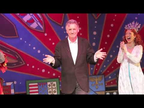 Trailer end card with the Spamalot crest over Broadway lights