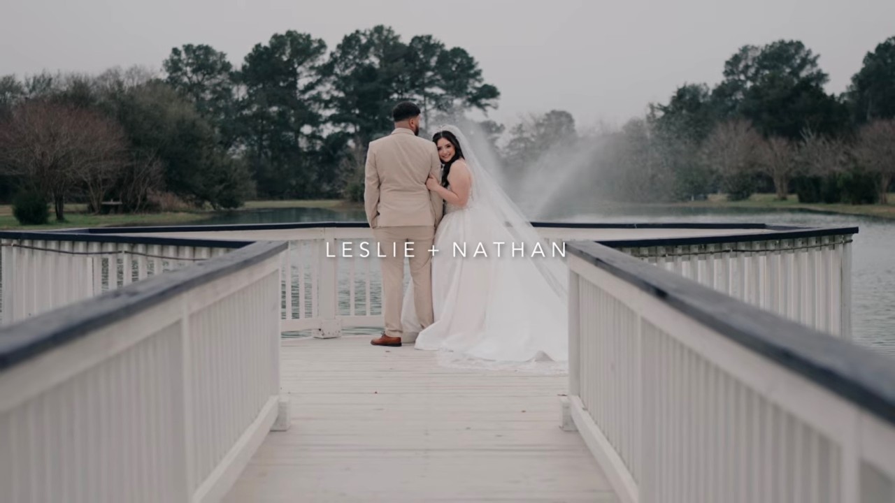 Couple walking a white pier, opening frame of the wedding teaser