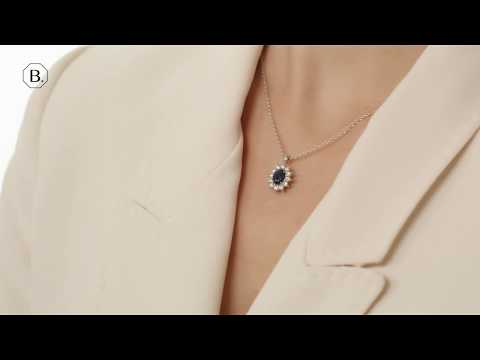 Entourage pendant in white gold with oval sapphire and round diamonds